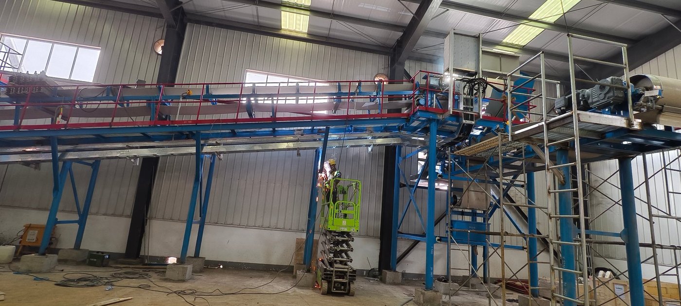 Wet pulp storage and reclaim conveying system for a pulp and paper mill upgrade